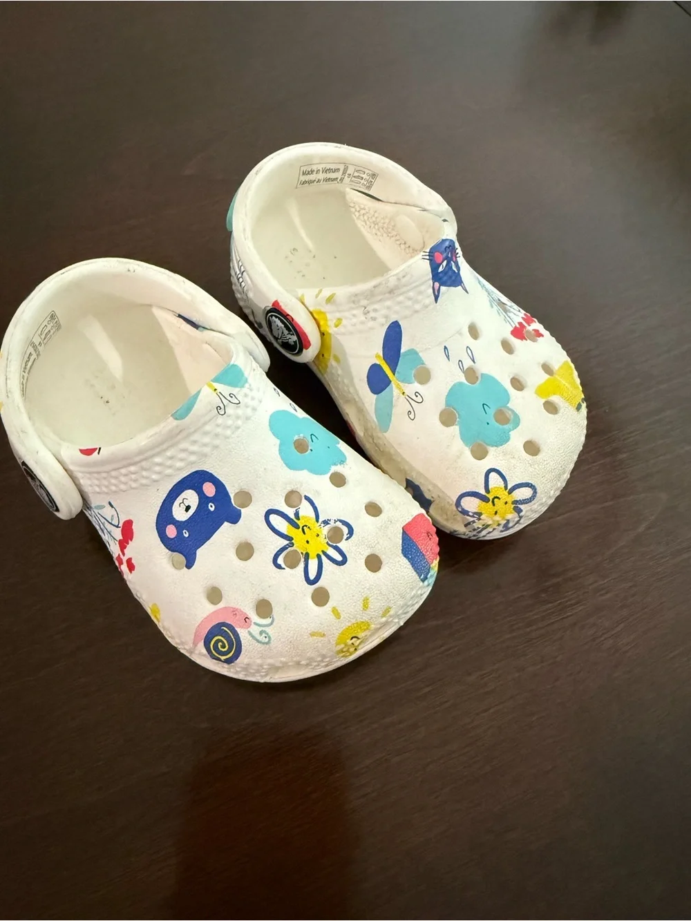 White infant Crocs with Colorful Floral & Animal Print size 4